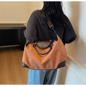 Retro matte brown travel bag with crossbody strap shown in a lifestyle indoor setting.