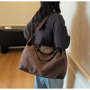 Large vintage matte suede travel bag with brown leather handles and shoulder strap.