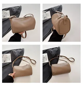 Multi-angle views of a taupe PU leather cylindrical pillow bag for women