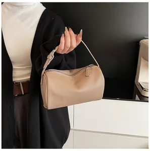 Detailed view of a khaki PU leather pillow bag with elegant pebble grain texture.