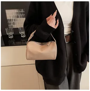 Elegant minimalist beige PU leather pillow bag with top zipper and adjustable handle