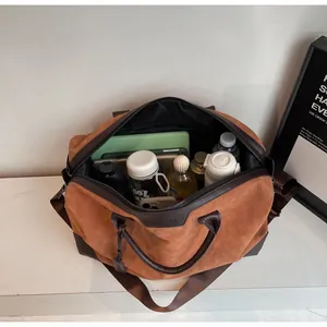 Interior detail of the large capacity brown travel bag showing storage for bottles and electronics