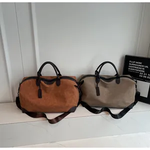High-capacity suede travel duffle bags in brown and khaki with adjustable straps