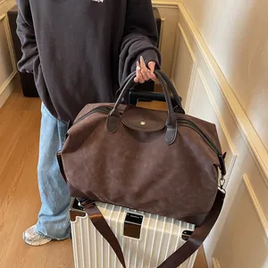 High quality retro brown frosted suede travel bag on white luggage suitcase for travel