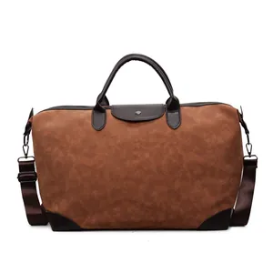 Vintage brown suede travel bag with adjustable shoulder strap for overnight trips