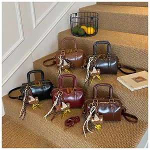 Trendy minimalist solid color Boston bags in multiple colors displayed on a staircase decor