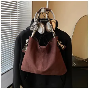 Large vintage matte suede hobo bag featuring a distinctive patterned braided strap.