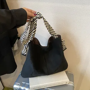 Large black frosted vintage tote bag featuring a distinctive striped ribbon strap