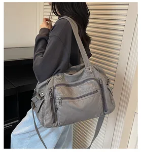 Fashionable large capacity grey PU leather tote bag with multiple pockets shown on model