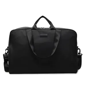 Front view of large black travel bag with sturdy handles and removable shoulder strap