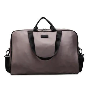 Front view of large capacity taupe travel bag with durable black nylon straps and handles