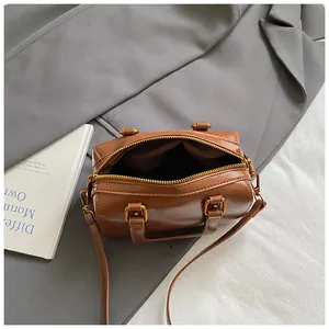 Detailed top view showing the spacious interior and gold zipper of this brown Boston bag