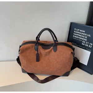 Large capacity brown travel duffel bag with dark brown handles and shoulder strap