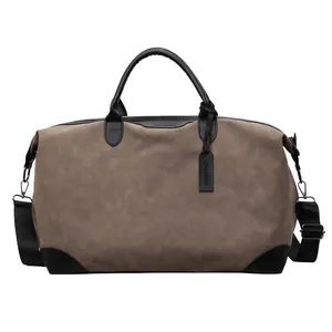 Large capacity grey nubuck travel duffel bag with black handles and shoulder strap