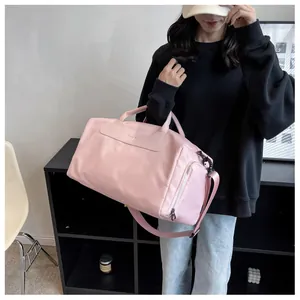 Detailed view of a pink large capacity fitness bag on a model for travel or swimming