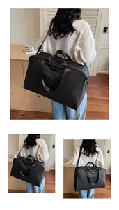 Large capacity black travel duffle bag for women, shown on a model in a lifestyle setting.