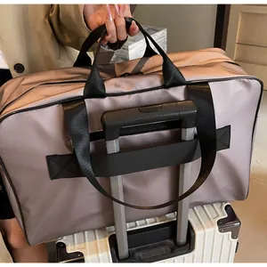 Detail view of large mauve travel bag with trolley sleeve on a white suitcase handle