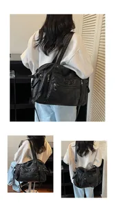Detailed visual of large black vintage PU leather tote bag featuring multiple pockets