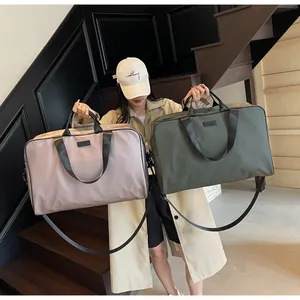 Women's large capacity nylon travel bags in olive and taupe shown by model on stairs