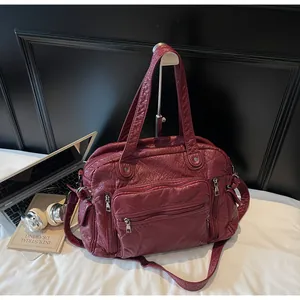 Vintage burgundy multi-pocket PU leather tote bag showcased on a professional workspace