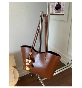 Grand sac fourre-tout marron avec pendentif ours en peluche sur un support