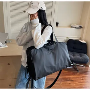 Stylish black large capacity travel duffel bag for women shown in a modern home setting