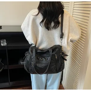 Back view of a stylish black vintage PU leather tote bag with a multi-pocket design