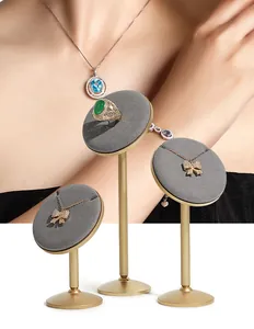 Professional set of golden jewelry display stands with grey velvet pads for counters