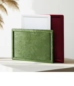Close-up detail of velvet jewelry display trays in green, burgundy, and white colors