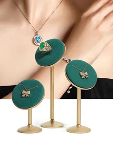 Set of three premium gold and green velvet jewelry display stands for necklaces and rings