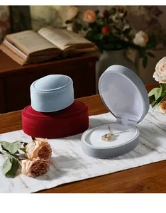 Premium oval flocking velvet jewelry storage boxes for rings and necklaces in lifestyle view