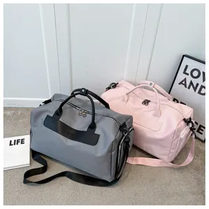 Large grey and pink sports duffel bags with waterproof fabric and separate shoe compartment
