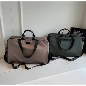 Detailed view of two large capacity nylon travel bags in mauve and forest green colors
