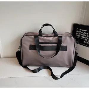 Detailed view of large capacity travel bag with trolley sleeve and shoulder strap