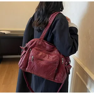 Woman wearing a large capacity burgundy vintage PU leather tote bag with multi-pockets