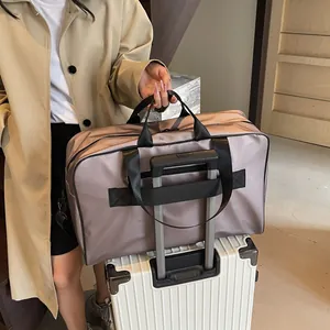 Large capacity women's travel duffle bag with trolley sleeve for short trips and gym.