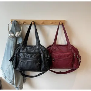 Vintage PU leather tote bags with multiple pockets hanging on a wooden wall rack