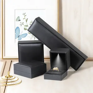 Premium black jewelry box set with integrated LED light for ring and pendant display.