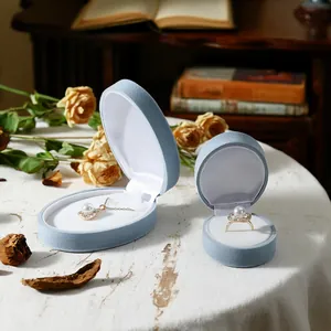 Elegant light blue flocking jewelry box set for rings and necklaces in a vintage setting.