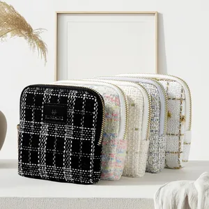 Elegant tweed jewelry storage pouch with zipper, perfect for luxury bracelets and rings
