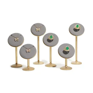 Premium set of six gray velvet jewelry display stands with gold-tone metal bases