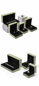 Various sizes of green suede jewelry boxes for rings and bracelets on white background