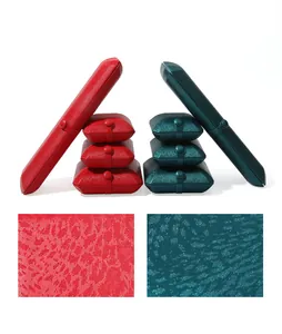 Detailed texture of retro jewelry boxes with button clasp in red and teal
