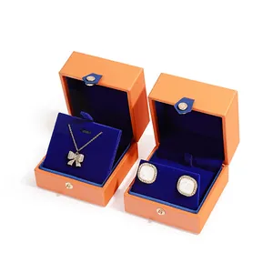 Premium orange PU leather jewelry boxes with blue velvet interior and button closure