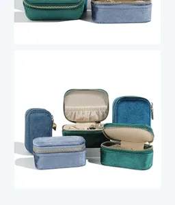 Macro view showing velvet texture and interior compartments of portable jewelry boxes
