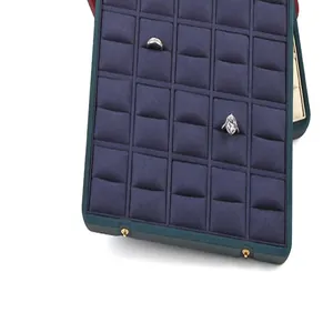 Close-up of a large capacity navy velvet jewelry display tray with 24 ring slots