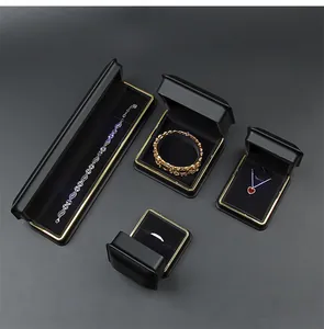 Premium black leather jewelry box set with gold trim for rings and bracelets