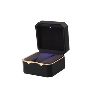 Octagonal black watch box with gold trim and built-in LED light for luxury display