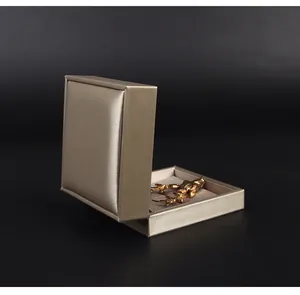 Champagne gold PU leather brooch storage box with an open view showing internal tray