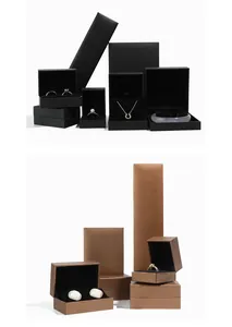Set of premium textured paper jewelry boxes in matte black and bronze finishes.